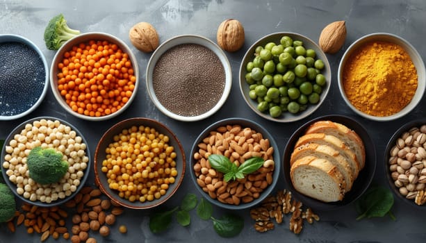 This image showcases a variety of high-fiber foods, arranged in a visually appealing manner on a gray surface. The assortment includes chickpeas, almonds, chia seeds, whole grain bread, pistachios, peas, and turmeric powder, highlighting the diverse range of options for incorporating fiber into ones diet.