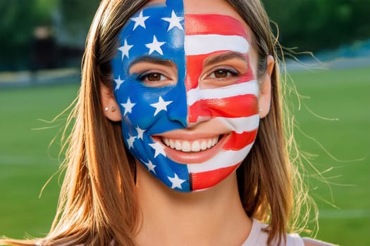 Face of happy smiling young female fan in sports stadium during competition, face painted in the image of American flag.