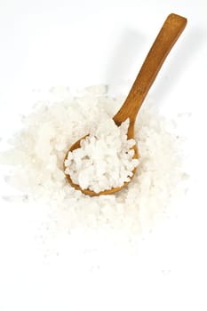 Sea salt crystals in clay pot with a wooden spoon