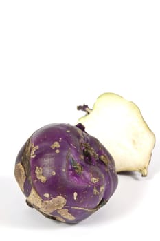 Kohlrabi vegetable with a rounded stem with dark purple color on a white background