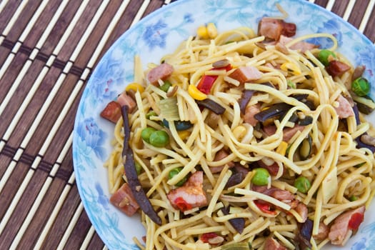Yellow noodles cooked with Chinese vegetable mix and smoked bacon