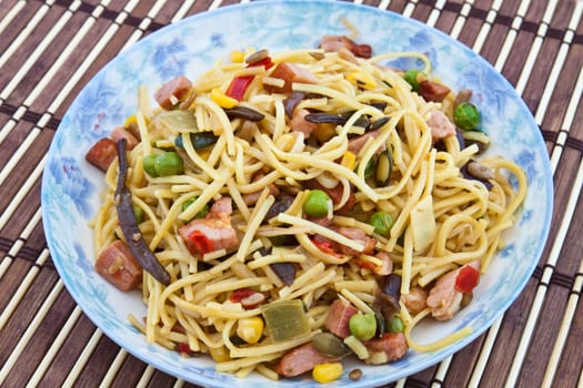 Yellow noodles cooked with Chinese vegetable mix and smoked bacon