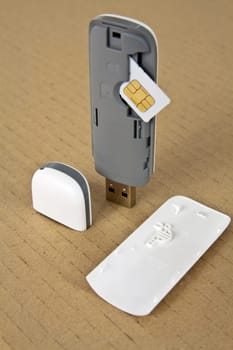 Wireless modem with a SIM card on a base of cardboard