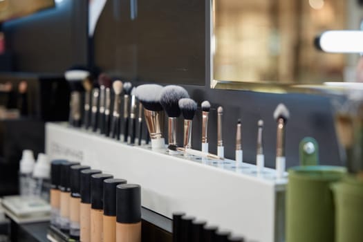 Set of brushes for make-up different sizes in cosmetics store. Many stuff for make up in shop