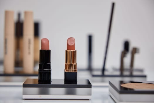 Two matte lipsticks on blurred background. Stunning pomades different shades