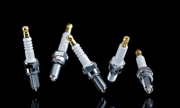 brand new spark plugs falling against a black background
