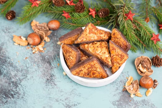 Nut corner triangles, traditional german sweets called Nussecke, covered with chocolate, christmas cake