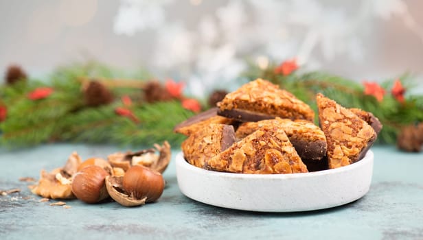 Nut corner triangles, traditional german sweets called Nussecke, covered with chocolate, christmas cake