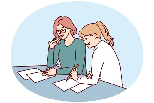 Women doing paperwork sitting at table in office of insurance company during conclusion of contract