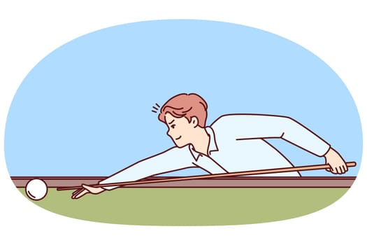 Man plays billiards leaning over table with cue in hands and taking aim, to put ball into hole. Guy is professional athlete playing billiards participating in competitions with cash prize