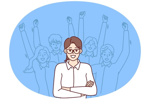 Woman leader standing with arms crossed near team located behind and making victorious wave of hands. Businesswoman leader or company manager posing for advertising banner of consulting corporation