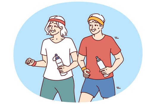 Elderly couple running and exercising outdoors having fun after retirement and enjoy active old age. Elderly men and women with water bottles do morning jog and lead healthy lifestyle