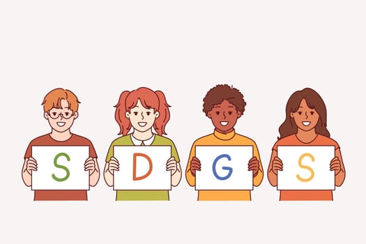 SDGS letters in hands of children calling to define and comply with sustainable development goals. Concept of SDGS plan to reduce emissions and develop economy for comfort of future generations