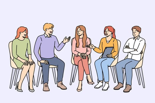 Group psychotherapy in alcoholics anonymous club discussing consequences of giving up beer and vodka. People sit on chairs arranged in semicircle during group psychotherapy session