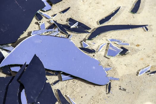 Detail of broken glass thrown in the trash, crime