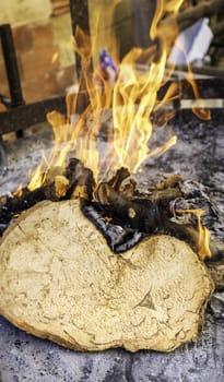 Detail of burning wood to prepare a barbecue