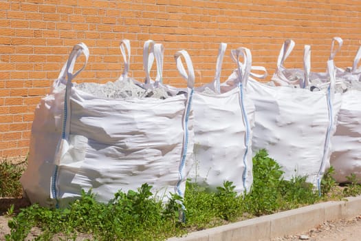 White garbage bags with building rubble and bricks, Germany