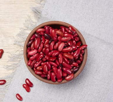 Raw red beans in a plate on the table, top view