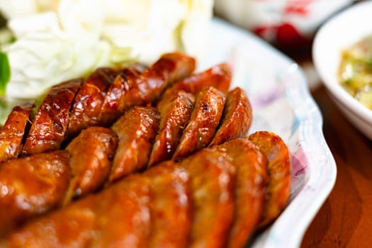 Northern Thai grilled sausage in white plate. Northern Thai Spicy Sausage.
