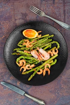 Seasonal salad with prawns, green asparagus. Boiled shrimp with green asparagus.
