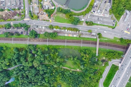 Top view of the urban lake. Lake, road in the city and parking