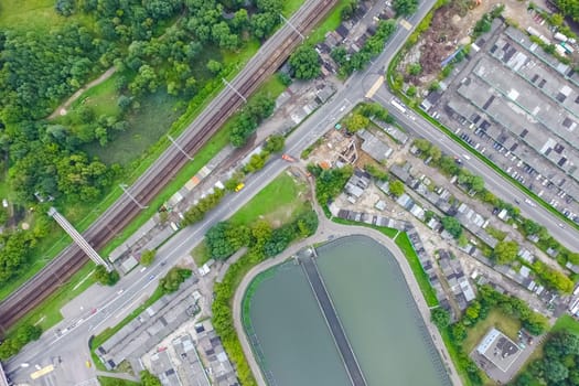 Top view of the urban lake. Lake, road in the city and parking
