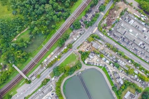 Top view of the urban lake. Lake, road in the city and parking