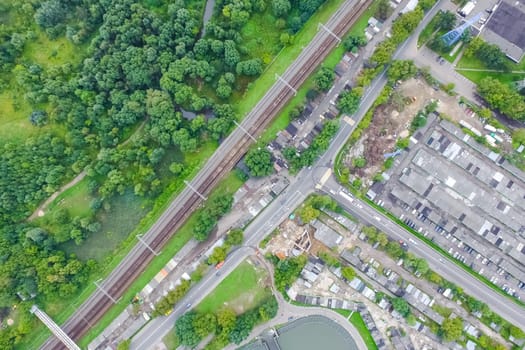 Top view of the urban lake. Lake, road in the city and parking