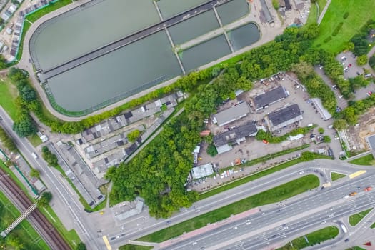 Top view of the urban lake. Lake, road in the city and parking