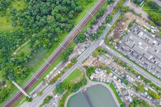 Top view of the urban lake. Lake, road in the city and parking