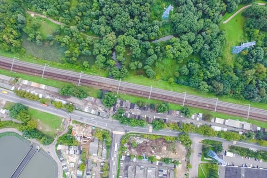 Top view of the urban lake. Lake, road in the city and parking