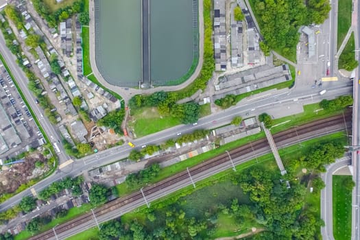 Top view of the urban lake. Lake, road in the city and parking