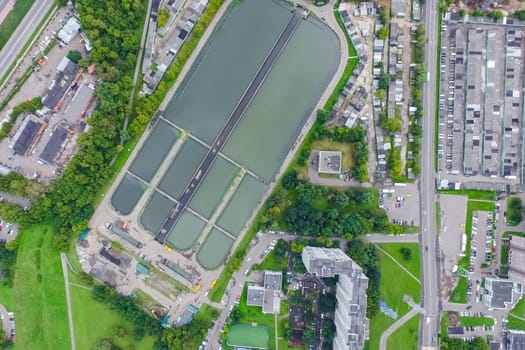 Top view of the urban lake. Lake, road in the city and parking