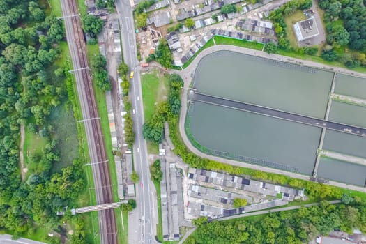 Top view of the urban lake. Lake, road in the city and parking