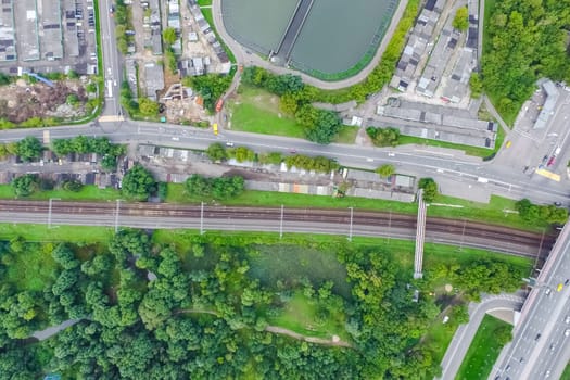 Top view of the urban lake. Lake, road in the city and parking