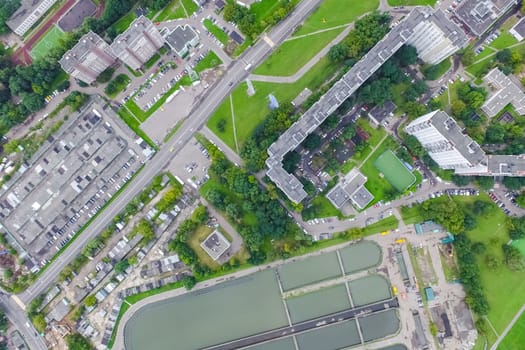 Top view of the urban lake. Lake, road in the city and parking