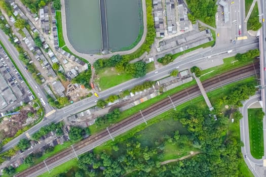 Top view of the urban lake. Lake, road in the city and parking