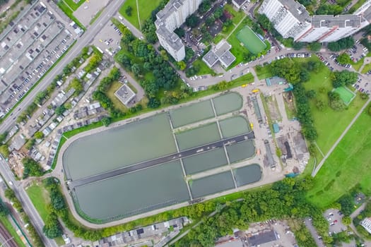Top view of the urban lake. Lake, road in the city and parking