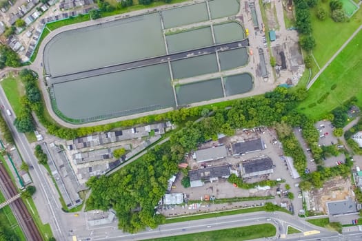 Top view of the urban lake. Lake, road in the city and parking