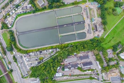 Top view of the urban lake. Lake, road in the city and parking