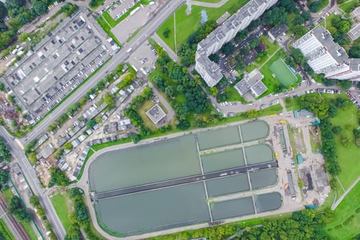 Top view of the urban lake. Lake, road in the city and parking