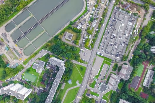 Top view of the urban lake. Lake, road in the city and parking