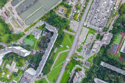 Top view of the urban lake. Lake, road in the city and parking