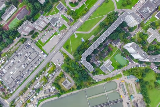 Top view of the urban lake. Lake, road in the city and parking