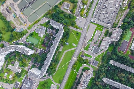 Top view of the urban lake. Lake, road in the city and parking