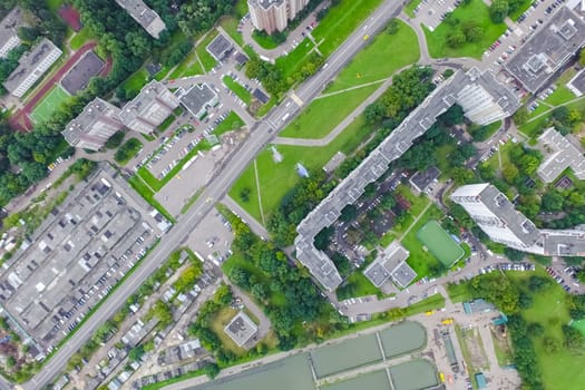 Top view of the urban lake. Lake, road in the city and parking
