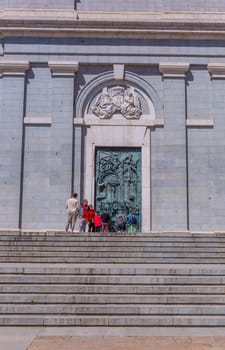Madrid, Spain: April 24, 2024: People at the entrance of the Almudena Cathedral, Santa Maria la Real de La Almudena.