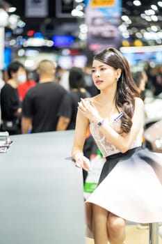 Nonthaburi, Thailand - MAR 26, 2023 Unidentified model poses with a car at The 44th Bangkok international motor show 2023 at IMPACT Arena, Muang Thong Thani, Nonthaburi, Thailand.
