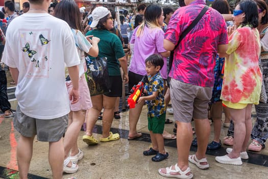 Siam Square, Bangkok, Thailand - APR 13, 2024 Songkran Festival, The short action of people joins celebrations of the Thai New Year or Songkran in Siam Square Bangkok, Thailand.