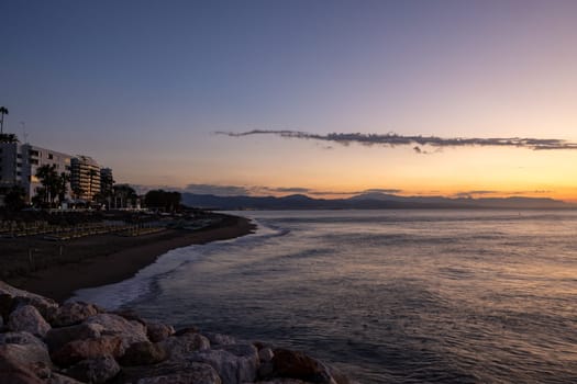 View of Bajondillo beach in Torremolinos just before sunrise. Costa del Sol, Spain